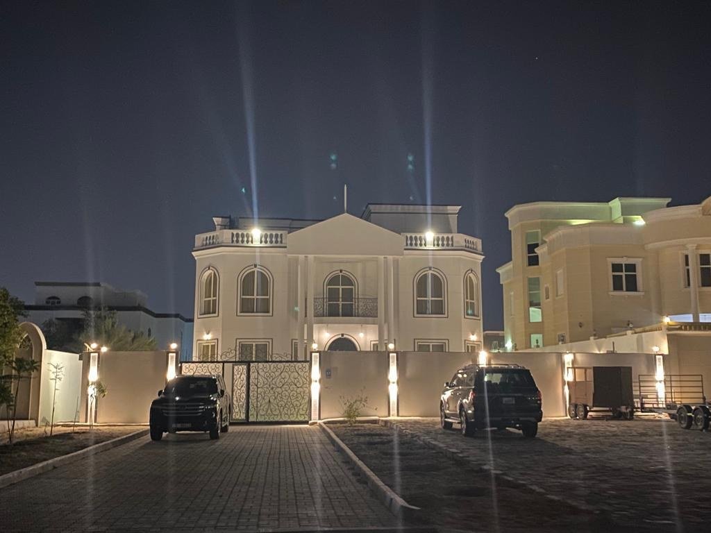 A grand neo-classical residence built around a skylit double-height atrium — white columns, wrought-iron balustrades and polished marble beneath a single circular oculus.