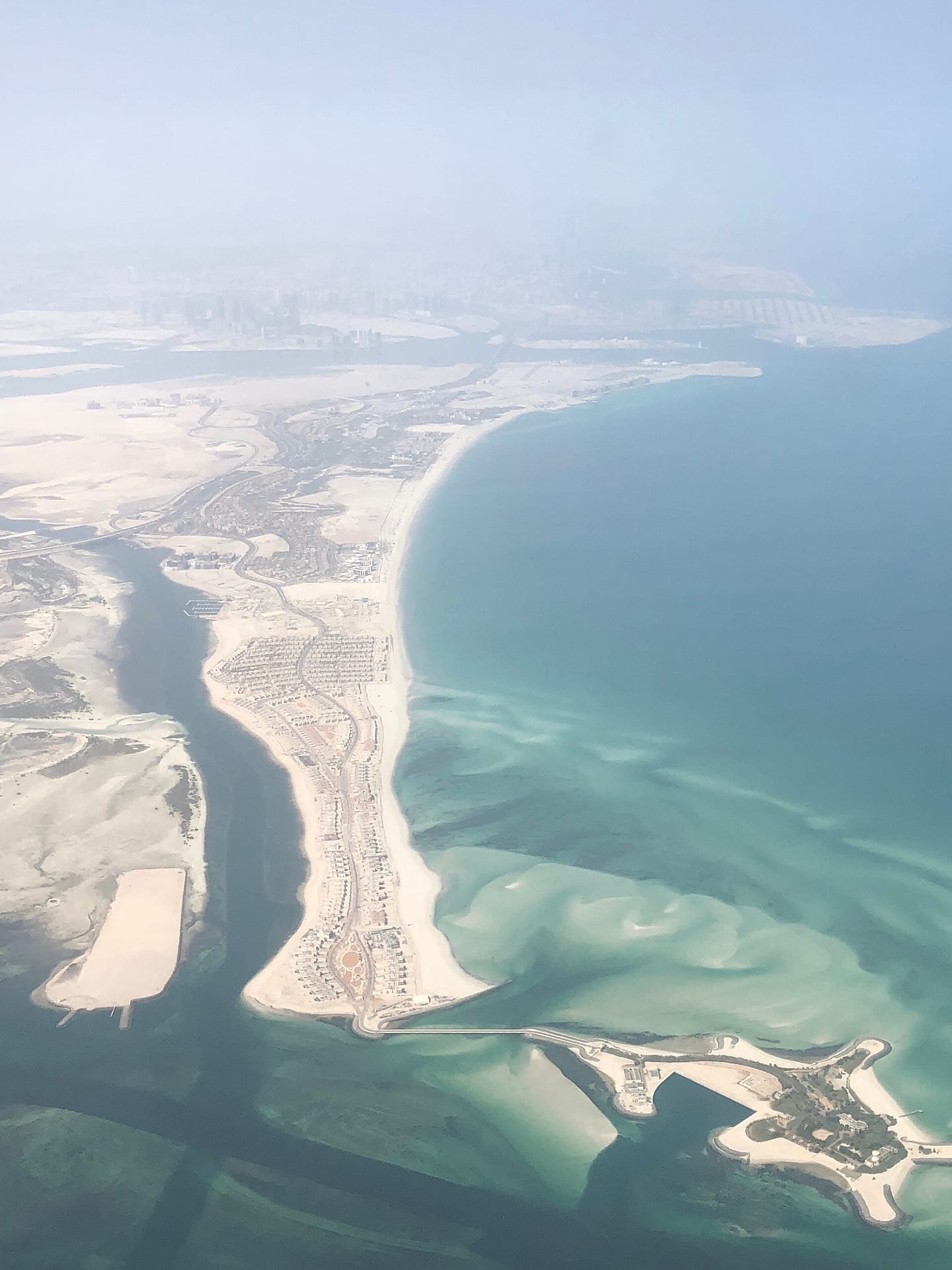 A contemporary beachfront villa on Saadiyat — open-plan living, floor-to-ceiling glass and a pool deck that opens straight onto the dunes and shoreline.